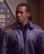 Ensign Travis Mayweather wearing a command division officer's excursion jacket, 2151